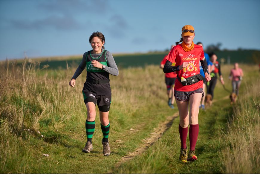 two people running in a field